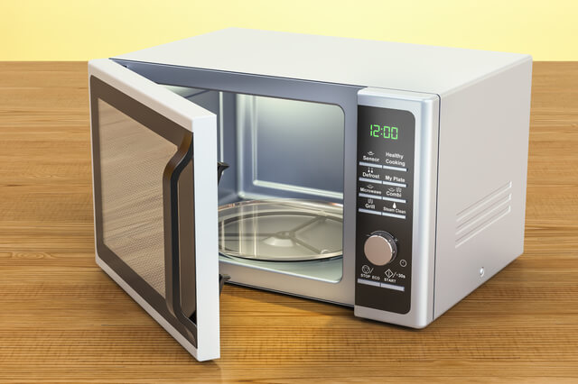 Microwave on the wooden table. 3D rendering